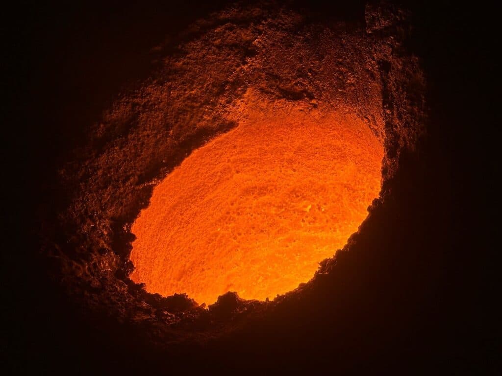 Interior of an induction furnace being patched and repaired with DFP India refractory